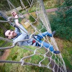 Man climbing cargo net at Go Ape Aberfoyle