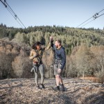 Celebratory high five of man and woman on the final zipline at Go Ape Aberfoyle